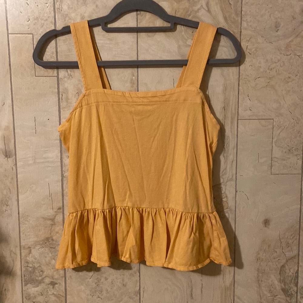 Orange tank top. Ruffle detail on bottom. Size small.